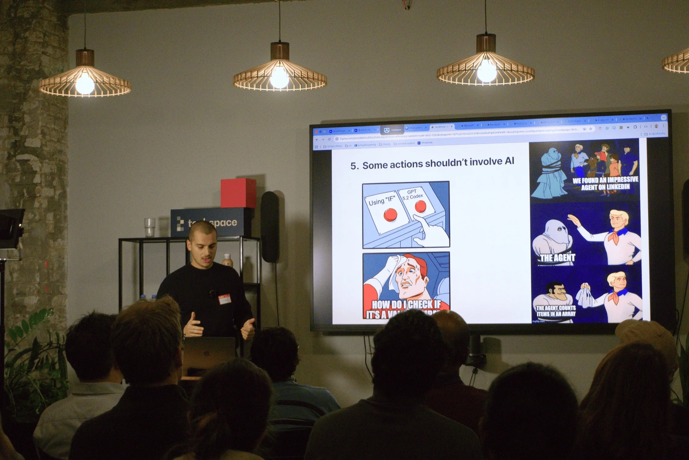 Guillaume presenting an AI efficiency talk to a seated audience, next to a slide reading: Some actions shouldn't involve AI